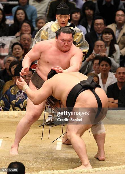 Sumo grand champion Hakuho pushes out Aminishiki to win during the day one of the Grand Sumo Spring Tournament at Osaka Prefectural Gymnasium on...