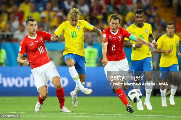 Neymar of Brazil competes with Granit Xhaka and Stephan Lichtsteiner of Switzerland during the 2018 FIFA World Cup Russia group E match between...