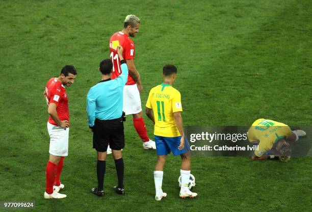 Valon Behrami of Switzerland is shown a yellow card by referee Cesar Ramos after making a foul on Neymar Jr of Brazil during the 2018 FIFA World Cup...