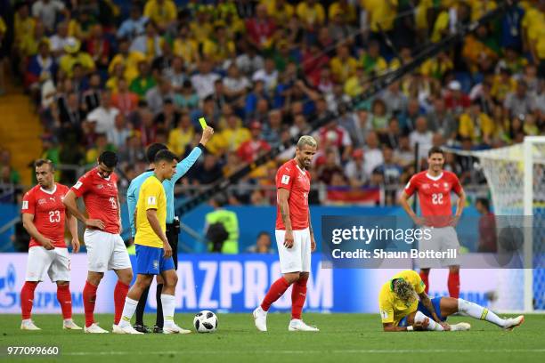 Valon Behrami of Switzerland is shown a yellow card by referee Cesar Ramos after making a foul on Neymar Jr of Brazil during the 2018 FIFA World Cup...