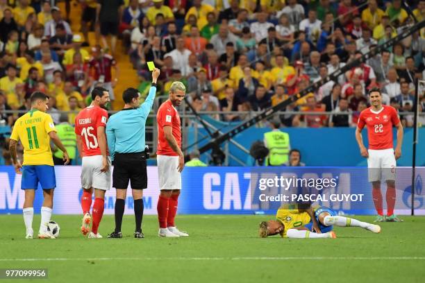 Brazil's forward Neymar reacts after he was tackled during the Russia 2018 World Cup Group E football match between Brazil and Switzerland at the...