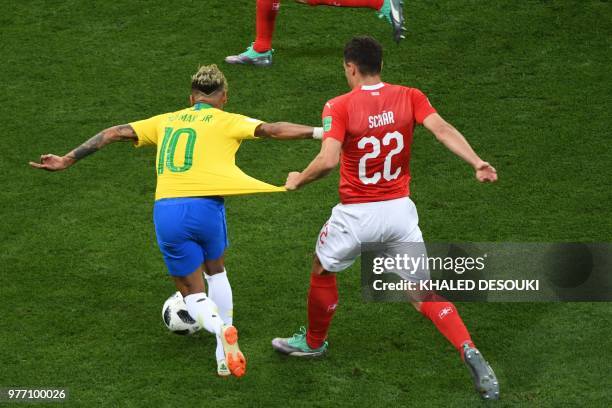Switzerland's defender Fabian Schaer pulls the jersey of Brazil's forward Neymar during the Russia 2018 World Cup Group E football match between...