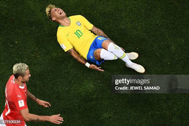Brazil's forward Neymar reacts after beeing tackled by Switzerland's midfielder Valon Behrami during the Russia 2018 World Cup Group E football match...