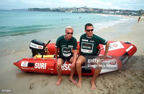 Eddie Irvine of Northern Ireland with JaguarF1 teammate Luciano Burti of Brazil during some IRB surf rescue boat races on Bondi Beach ahead of...
