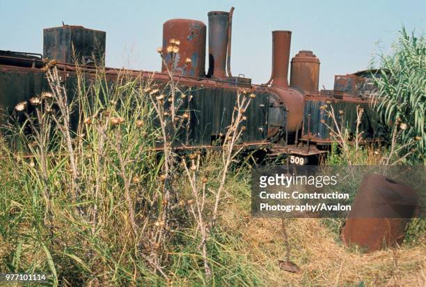 Rusted tones on the locomotive dump at Vartholomio on the Greek Peloponnese. The two Z Class 2-6-0S are No 7504 left SA Graffenstaden 1890 and right...