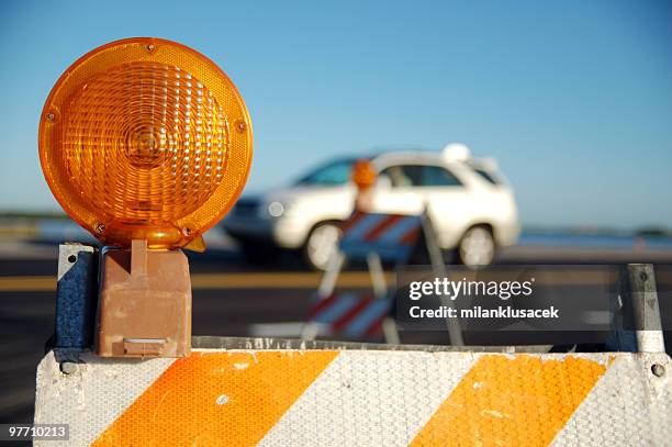 the light on a construction barrier on a road - barricade 個照片及圖片檔