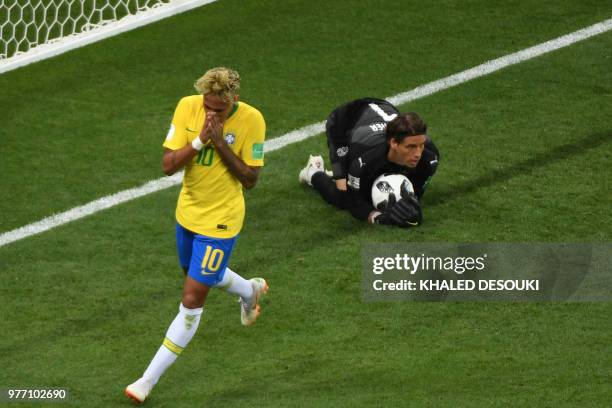 Switzerland's goalkeeper Yann Sommer makes a save next to Brazil's forward Neymar during the Russia 2018 World Cup Group E football match between...