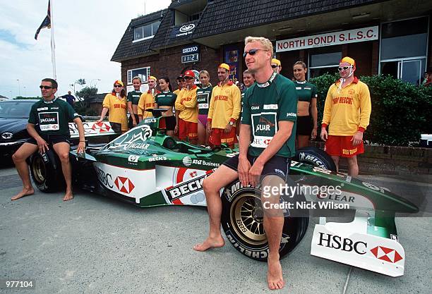 Eddie Irvine of Northern Ireland with JaguarF1 teammate Luciano Burti of Brazil outside the Bondi Surf Life Saving Club during some IRB surf rescue...