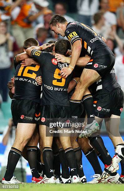 The Tigers celebrate the winning try during the round one NRL match between the Wests Tigers and the Manly Warringah Sea Eagles at the Sydney...