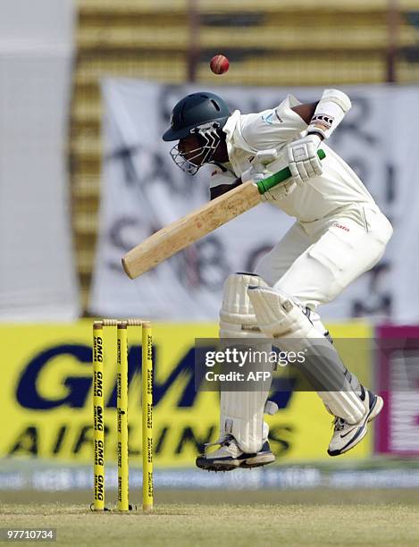 Bangladeshi cricketer Shahadat Hossain tries to avoid a bouncer from unseen England cricketer Stuart Broad during the third day of the first Test...