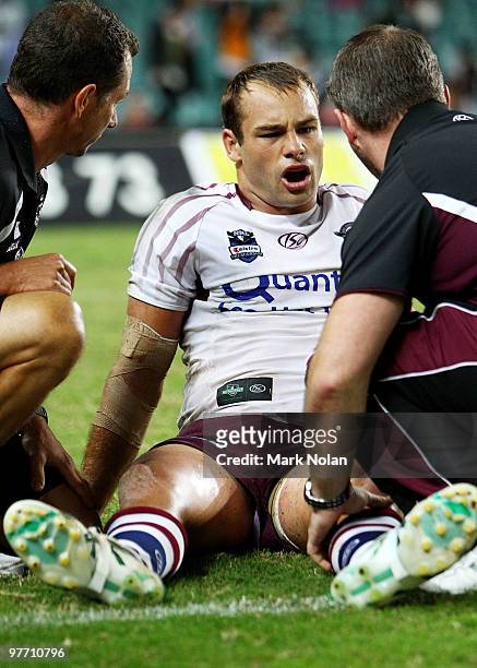 Brett Stewart of the Eagles receives attention for a knee injury during the round one NRL match between the Wests Tigers and the Manly Warringah Sea...