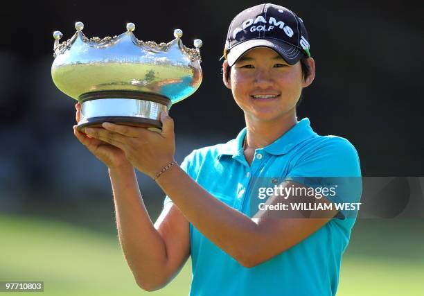 Yani Tseng of Taiwan holds up the trophy after winning the women's Australian Open golf tournament at the Commonwealth Club in Melbourne on March 14,...