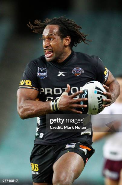 Lote Tuqiri of the Tigers makes a line breakduring the round one NRL match between the Wests Tigers and the Manly Warringah Sea Eagles at the Sydney...