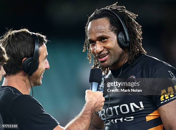 Lote Tuqiri of the Tigers talks to Andrew Johns after the round one NRL match between the Wests Tigers and the Manly Warringah Sea Eagles at the...