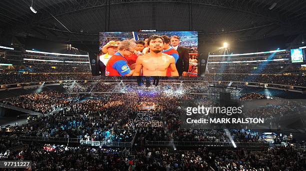 Manny Pacquiao of the Philippines is projected onto a large TV screen before his their World Boxing Organization welterweight title fight against...