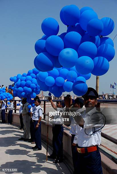 Indian securitymen hold balloons as Bahujan Samaj Party supporters attend a rally in Lucknow on March 15, 2010. Thousands of supporters of the party...