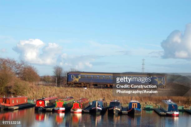 Class 153 Sprinter DMU passes the new Rufford Marina on approach to Rufford station with an Ormskirk - Preston shuttle service. March 2005.