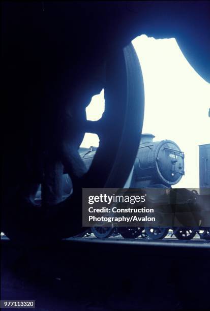 Stanier 8F 2-8-0 No.48529 seen from the inspection pit beneath another engine at Patricroft motive power depot, Manchester.
