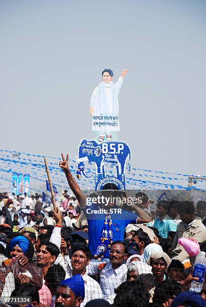 Bahujan Samaj Party supporter wears a hat with the party symbol the elephant and a drawing of party leader and Uttar Pradesh state Chief Minister...