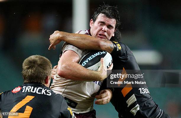 Jamie Lyon of the Eagles is tackled during the round one NRL match between the Wests Tigers and the Manly Warringah Sea Eagles at the Sydney Football...