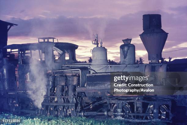 As dawns breaks over Fabrica on rhe Philippine island of Negros an old Lima two truck Shay raises steam for a days tripping around the sawmill on the...