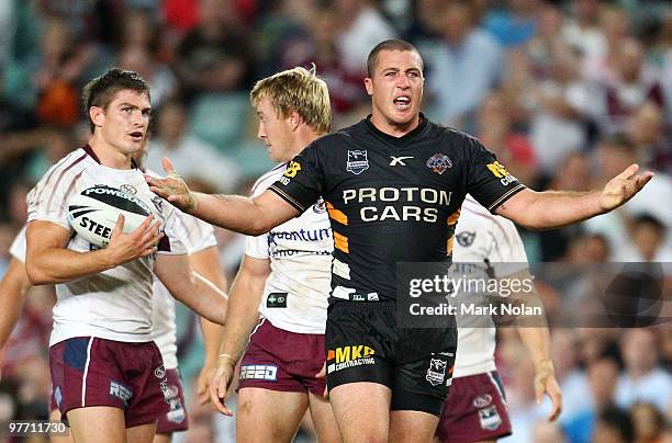 Bryce Gibbs of the Tigers disputes a decision during the round one NRL match between the Wests Tigers and the Manly Warringah Sea Eagles at the...