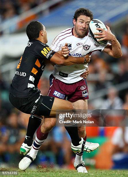 Benji Marshall of the Tigers tackles Chris Bailey of the Eagles during the round one NRL match between the Wests Tigers and the Manly Warringah Sea...