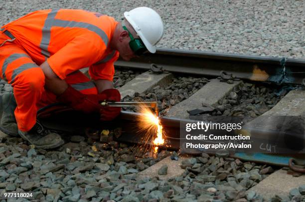 Cutting old rail at Bourne End on Sunday 24th August 2003 as part of the West Coast Main Line upgrade, United Kingdom.