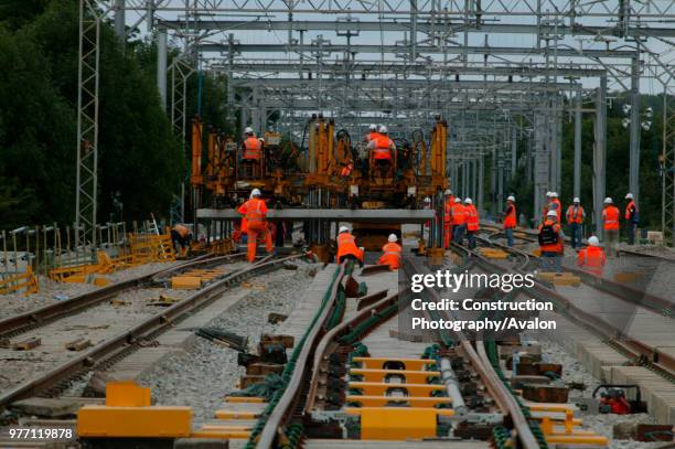New track sections being lowered into place at Bourne End in August 2003 during the West Coast Main Line upgrade, United Kingdom.
