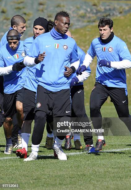 Inter Milan's forward Mario Balotelli and Argentinian defender and captain Javier Aldemar Zanetti warm-up with team mates during a training session...