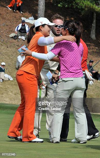 Inbee Park of South Korea and Mie Nakata of Japan react after holing out on the 18th green during the final round of the Yokohama Tire Golf...