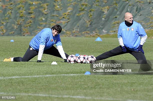 Inter Milan's Argentinian forward Alberto Milito Diego andArgentinian midfielder Esteban Cambiasso warm-up during a training session on the eve of...
