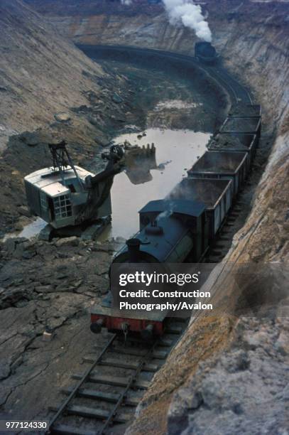 The working gullet at Nassington showing tippler wagons being loaded and unmined ore bed in the foreground. Assisting locomotive approaching to help...