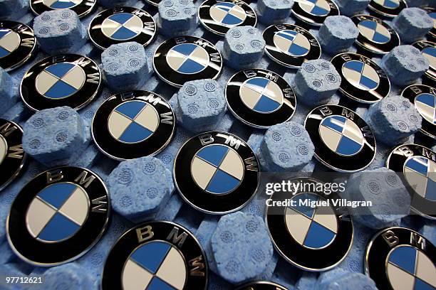 Logos are pictured in a tray on on the BMW 3-series production line at the BMW factory on March 15, 2010 in Munich, Germany. The German car maker...