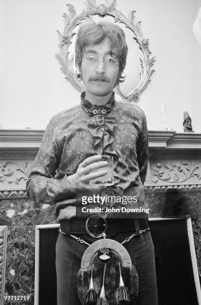 John Lennon wearing a frilly shirt and a sporran at the press launch for the Beatles' new album 'Sergeant Pepper's Lonely Hearts Club Band', held at...