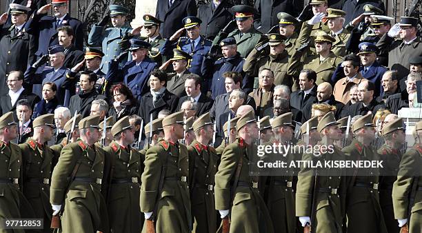 Soldiers of Hungarian honour guard march past members of the international diplomacy and military attache in front of the Parliament building on...