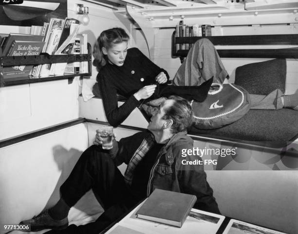 Married American actors Humphrey Bogart and Lauren Bacall on board a yacht, circa 1955.