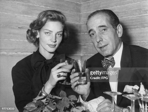 Married American actors Humphrey Bogart and Lauren Bacall attend a cocktail party at the Calvados cabaret club on the Champs Elysees, Paris, 1951.