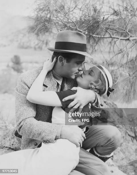 American actors John Boles and Claire Trevor rehearsing a love scene for 'Wild Gold', on location at Kernville, California, 1934. The film is...