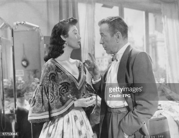 American actress Ava Gardner with Humphrey Bogart in a scene from 'The Barefoot Contessa', directed by Joseph L. Mankiewicz, 1954.