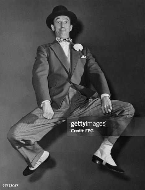 American actor Ray Bolger , performs his parodic 1920's-style soft-shoe dance from the Broadway review 'Three To Make Ready', 1946. Bolger is best...