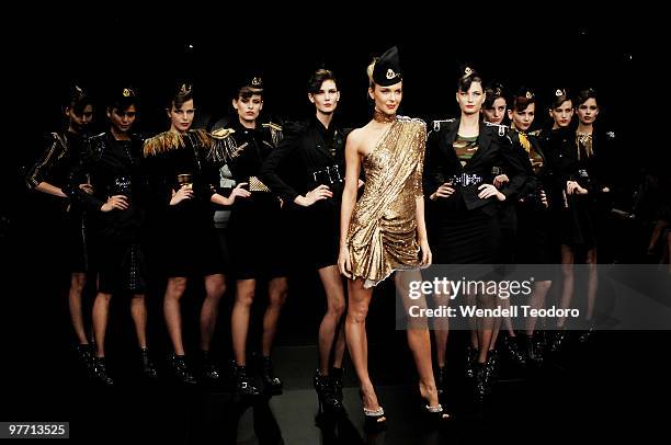 Jenifer Hawkins showcases a design by Toni Maticevski and models showcase designs by Nina Maya and Cue and Wayne Cooper on the catwalk at the Myer...