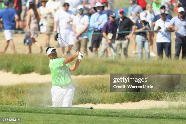 Kiradech Aphibarnrat of Thailand plays his second shot from a bunker on the eighth hole during the final round of the 2018 U.S. Open at Shinnecock...