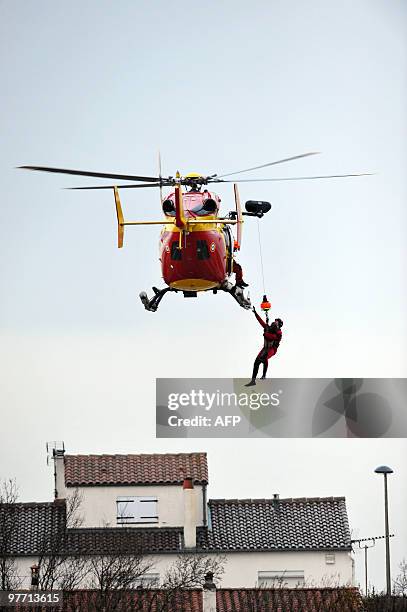 Child is rescued on February 28, 2010 in La Rochelle, western France, after hurricane-force winds, surging seas and driving rain lashed western...