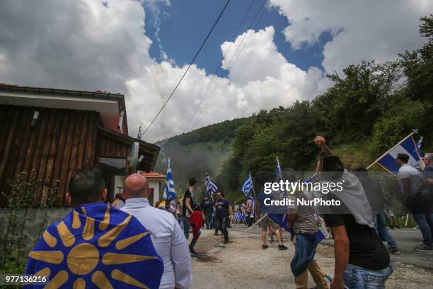 Protestors holding Greek flags clash with riot police during a protest at the village of Pisoderi near the border with Macedonia in northern Greece...