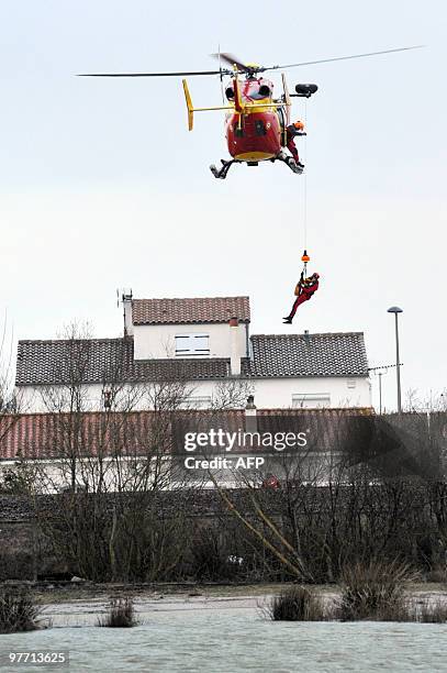 Child is rescued on February 28, 2010 in La Rochelle, western France, after hurricane-force winds, surging seas and driving rain lashed western...