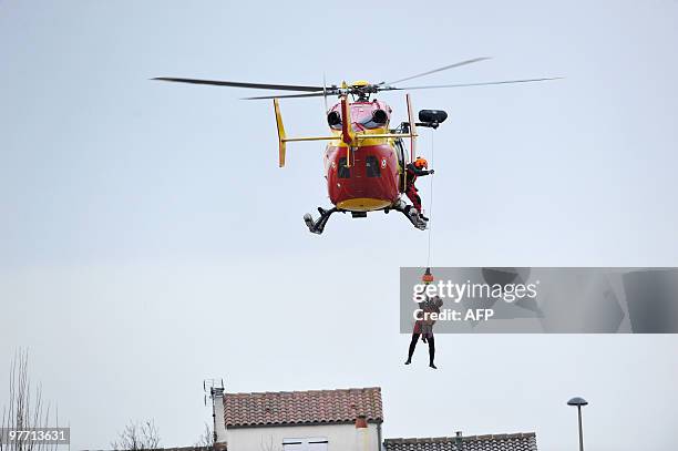 Child is rescued on February 28, 2010 in La Rochelle, western France, after hurricane-force winds, surging seas and driving rain lashed western...