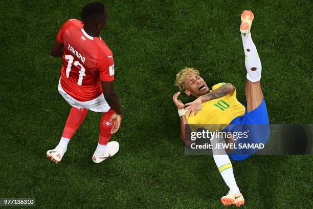 Brazil's forward Neymar reacts next to Switzerland's midfielder Denis Zakaria during the Russia 2018 World Cup Group E football match between Brazil...