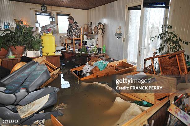 Woman waits for rescuers in her kitchen on February 28 as a result of heavy floods, in La Faute-sur-Mer western France. Dubbed "Xynthia", the...