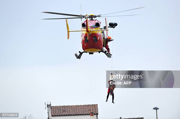 Child is rescued on February 28, 2010 in La Rochelle, western France, after hurricane-force winds, surging seas and driving rain lashed western...